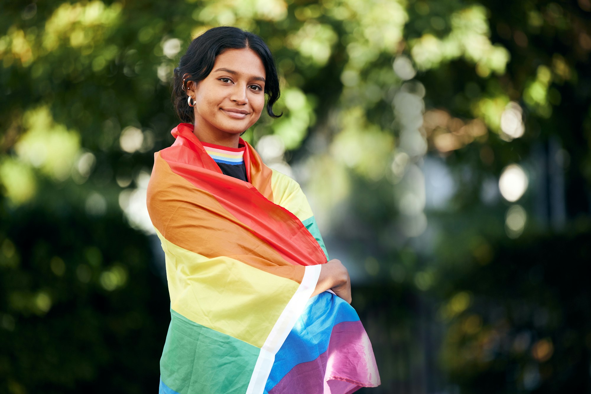 Portrait, woman and rainbow flag for pride, support and lgbtq awareness, sexuality freedom and quee